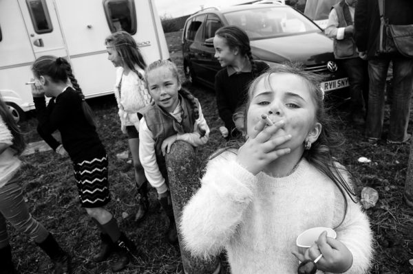 black and white photo of little girls, one of them is smoking a cigarette