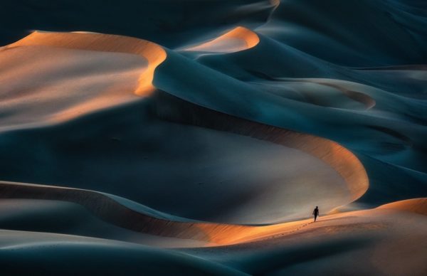 a person walking alone in the desert