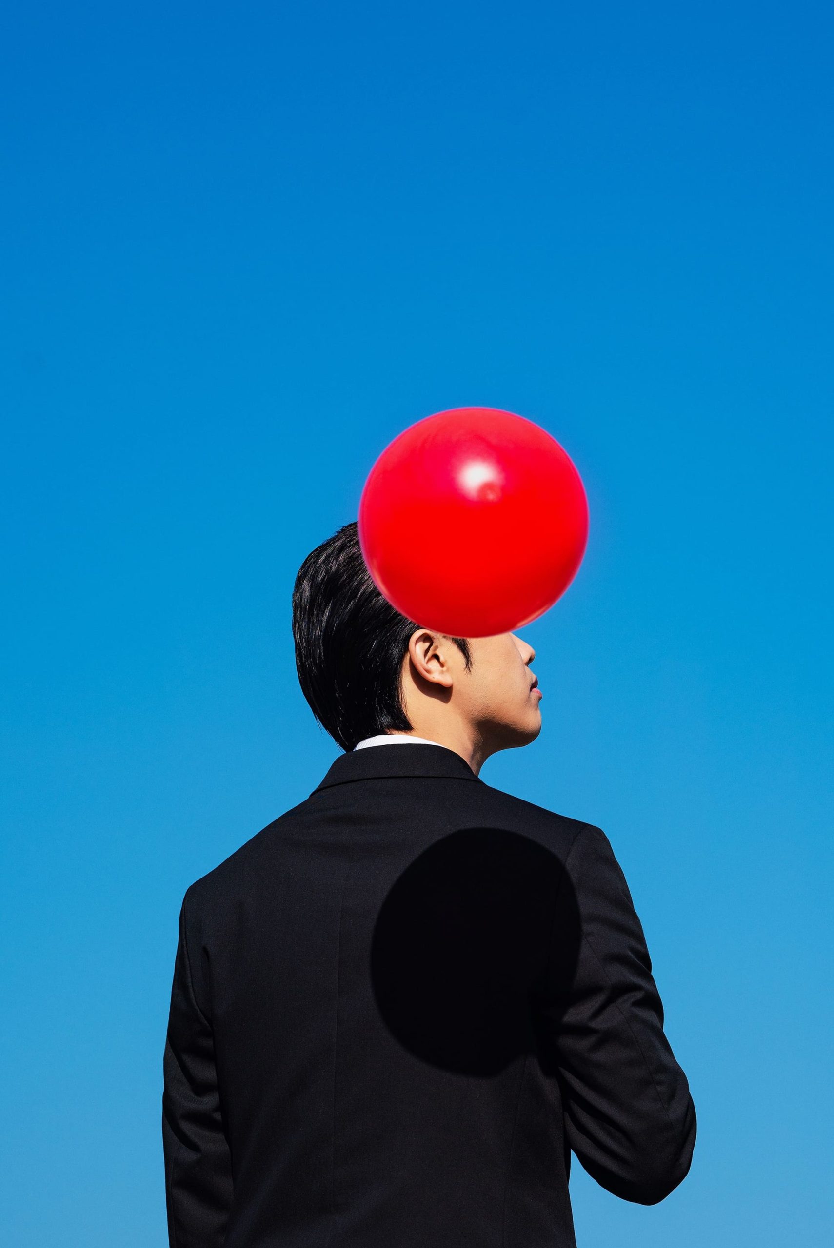 man with a red balloon